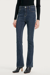 a lady in dark blue jeans with black high heels